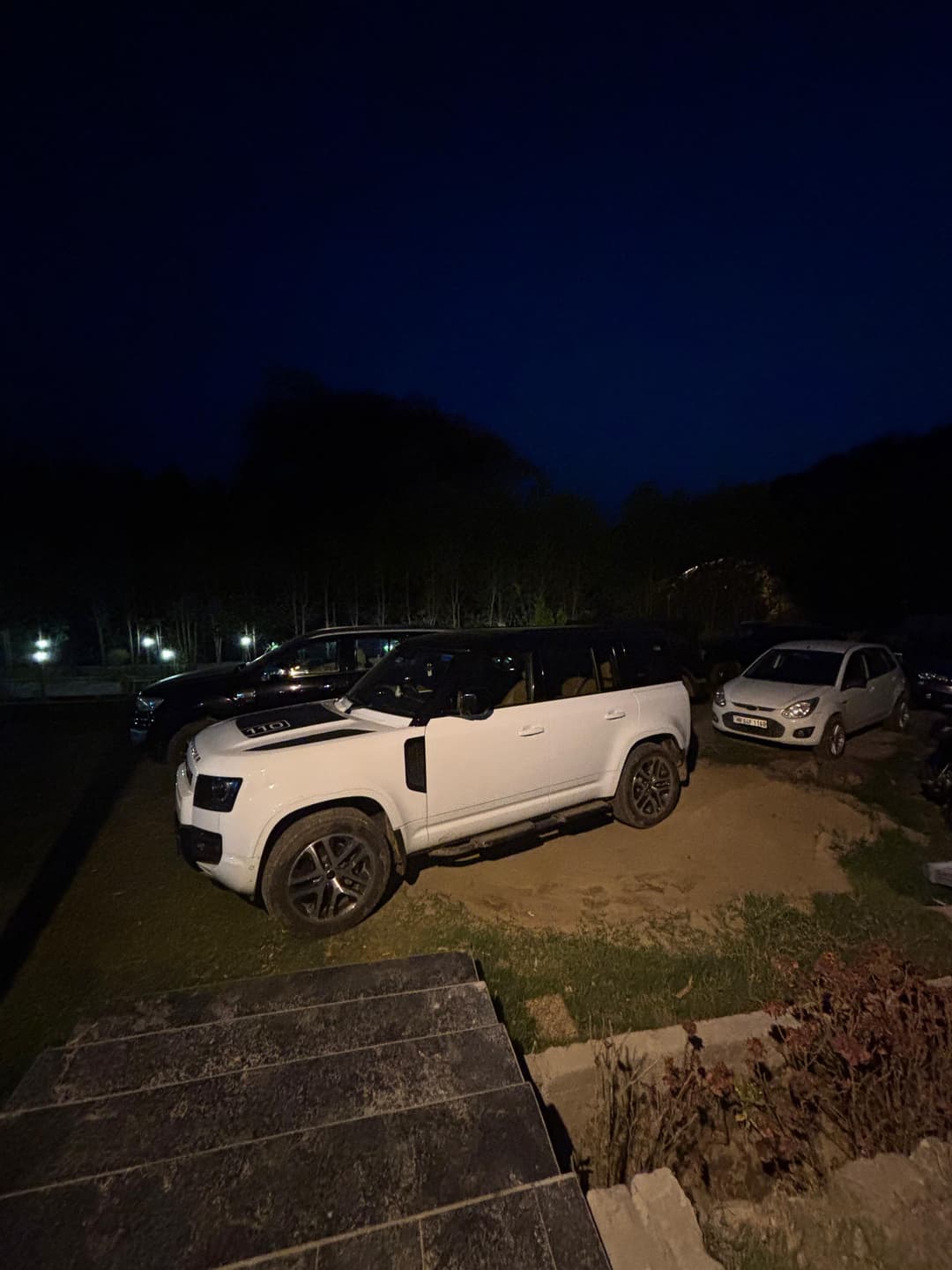 The resort lit up at night under a starry sky.